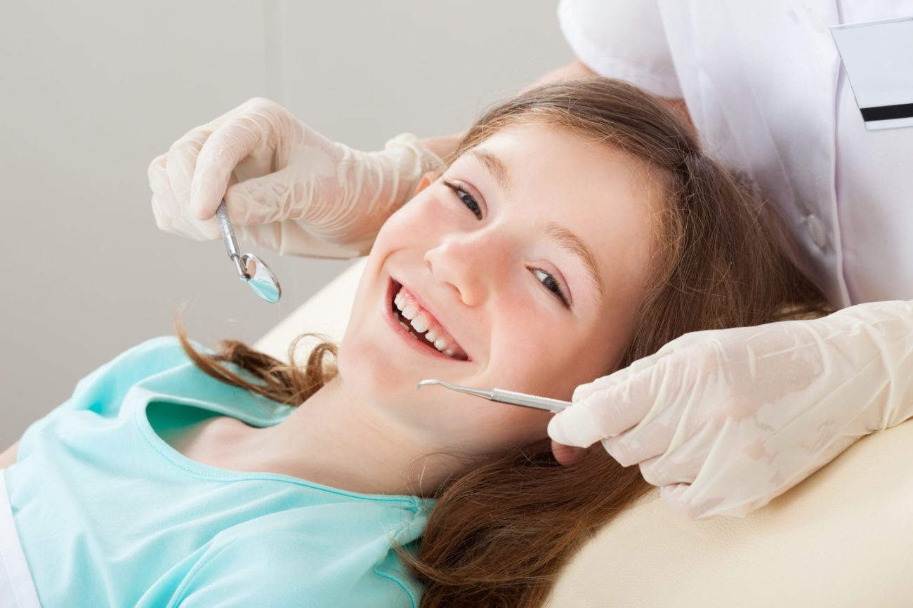 Happy Girl Undergoing Dental Treatment Pediatric dentistry cincinnati oh 